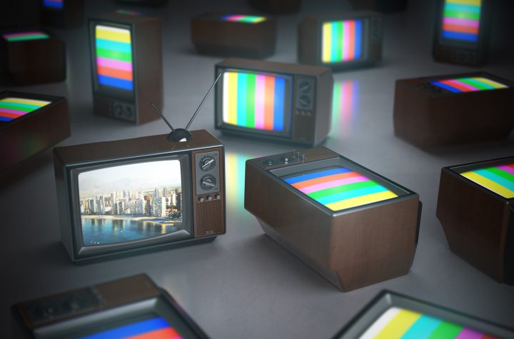 Pile of vintage TV with one in standby. TV channels concept