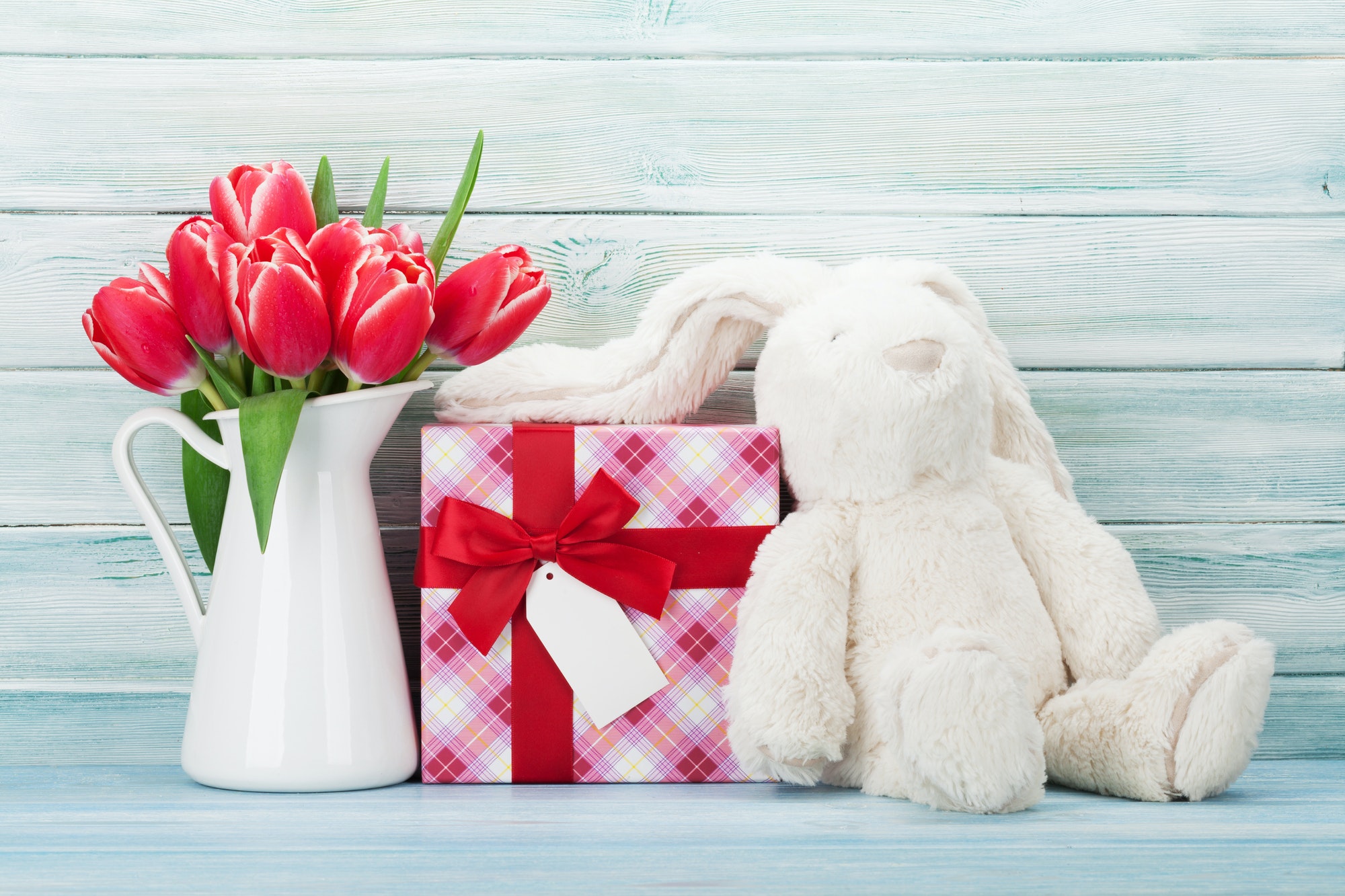Red tulip flowers and easter rabbit toy