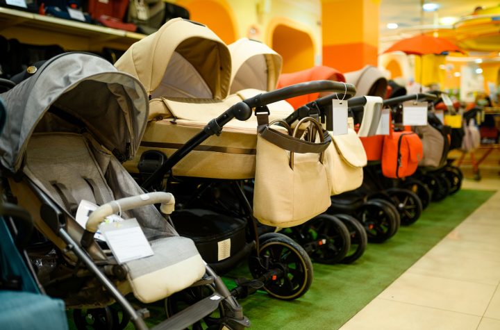 Row of baby strollers in children's store, nobody