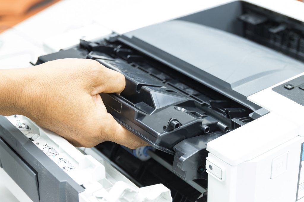 Technicians replacing toner in laser printer concept office supplies repair