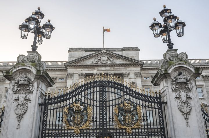 Royal Coat of Arms and the gates at Buckingham Palace, London, England