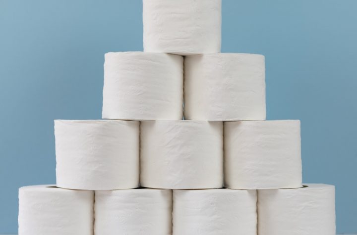 Stack of rolls of toilet paper on a blue background