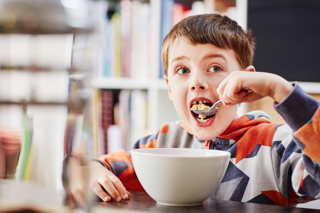 Young boy eating breakfast