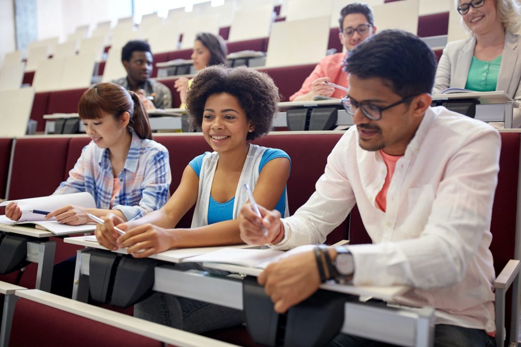 group of students with notebooks in lecture hall