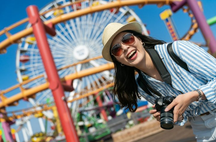 lady with camera on vacation at amusement park