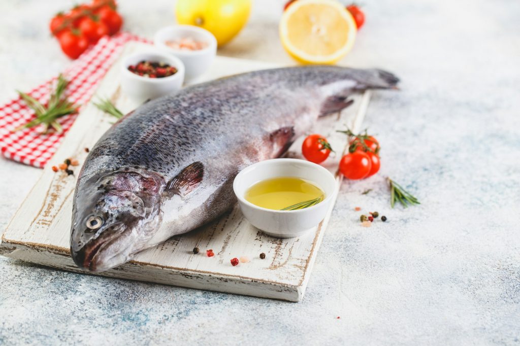 Raw rainbow trout light background