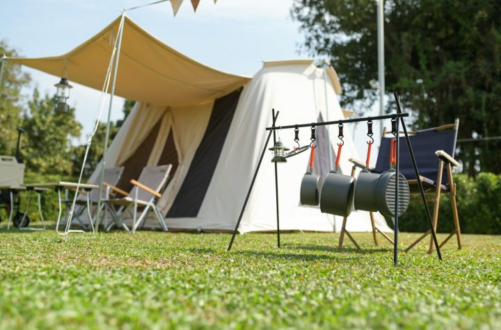 Tents and camping equipment on the lawn.
