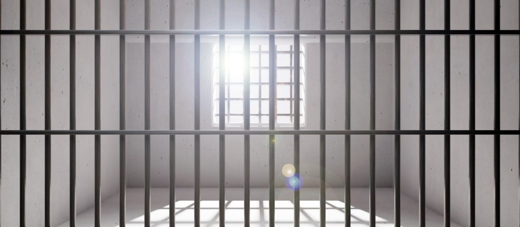 Prison cell with window, jail steel bars and concrete walls, empty dungeon interior. 3d render