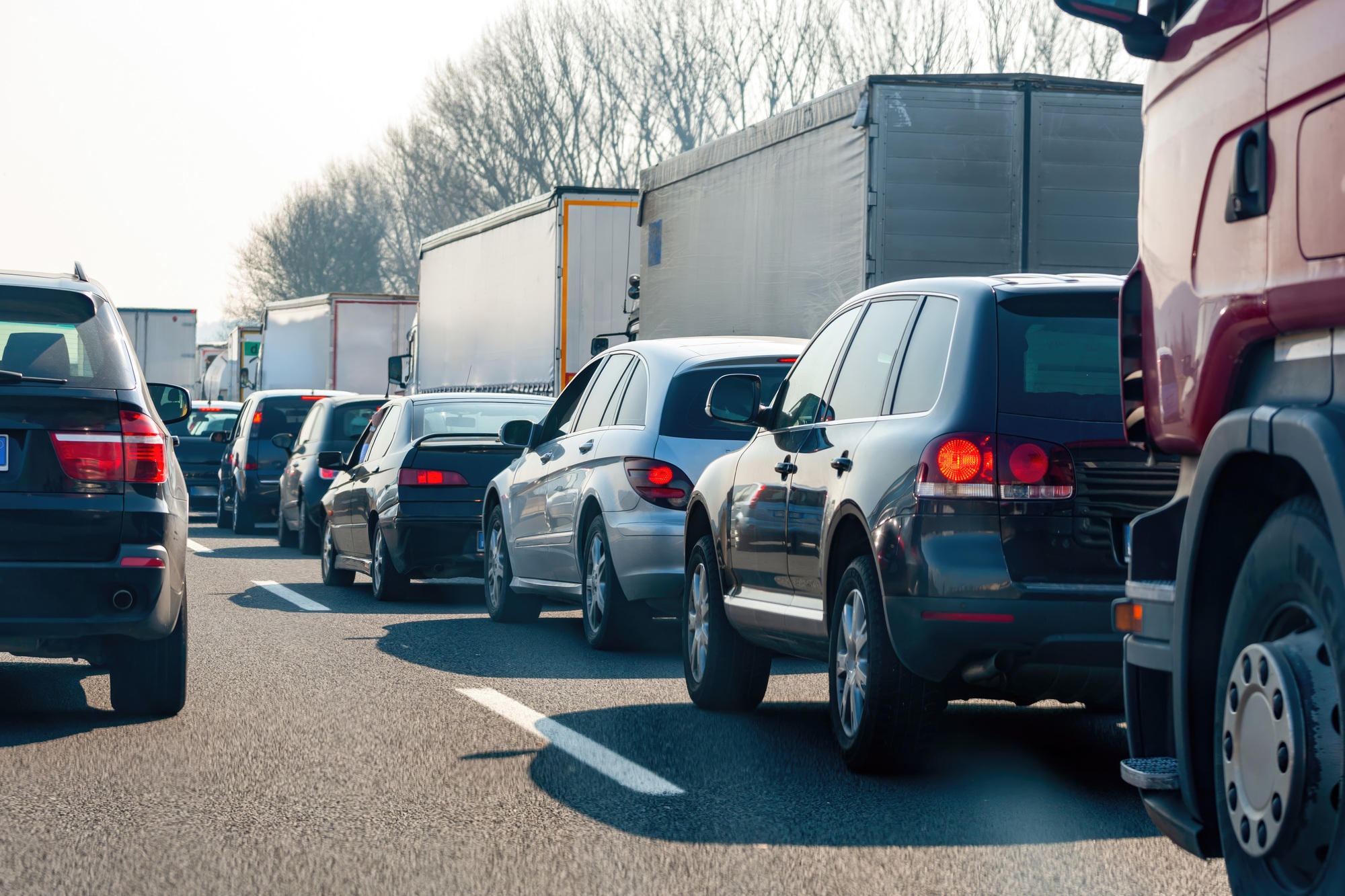 Traffic jam on highway with cars and trucks stuck in congestion