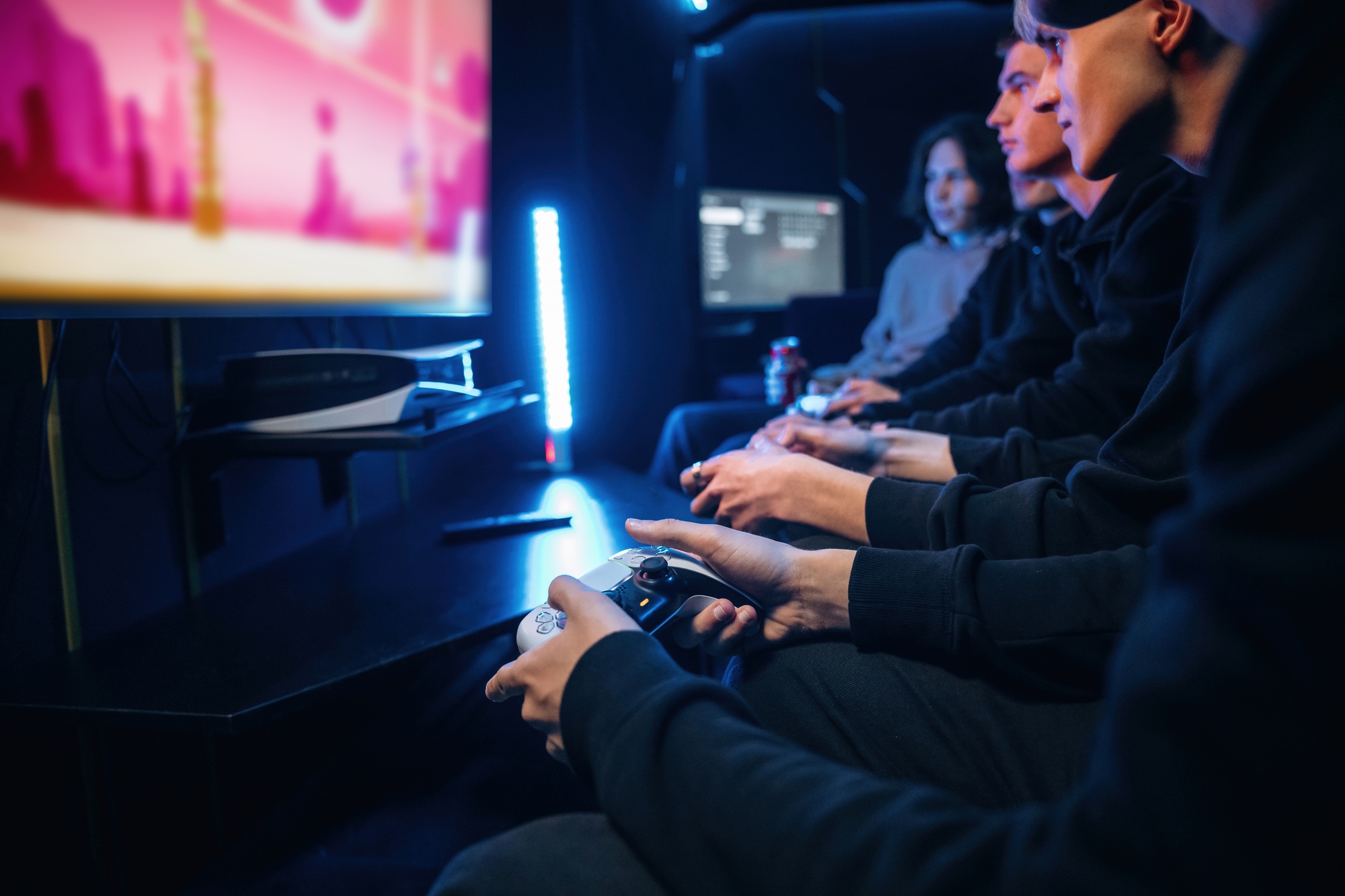 Young gamers are with console controllers indoors