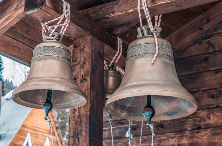 Bronze bells of an old wooden chapel. Old bronze bells in a village church