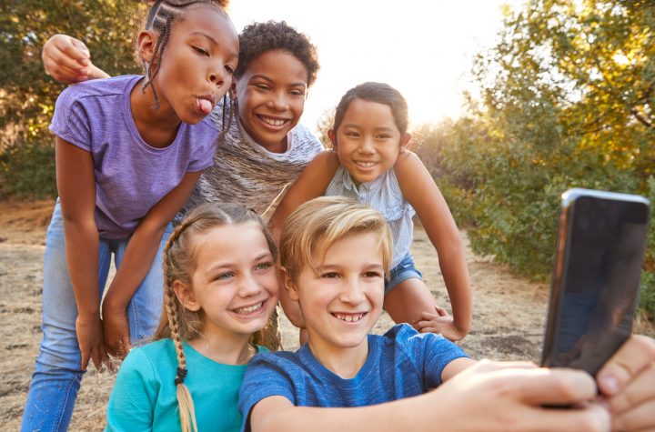 Group Of Multi-Cultural Children Posing For Selfie With Friends In Countryside Together