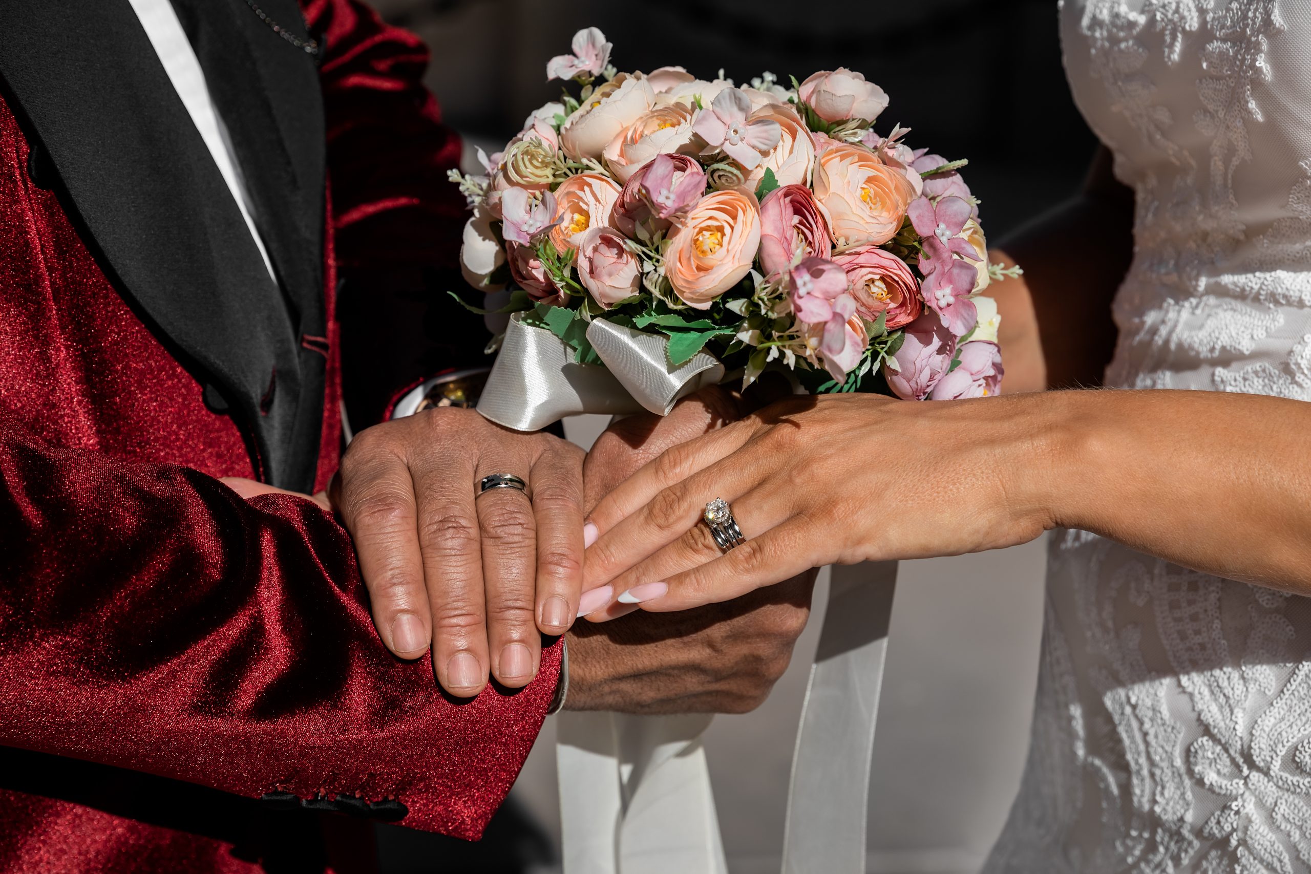 Closeup of bride and groom holding hands and showing rings on Wedding day, special occasion - Image