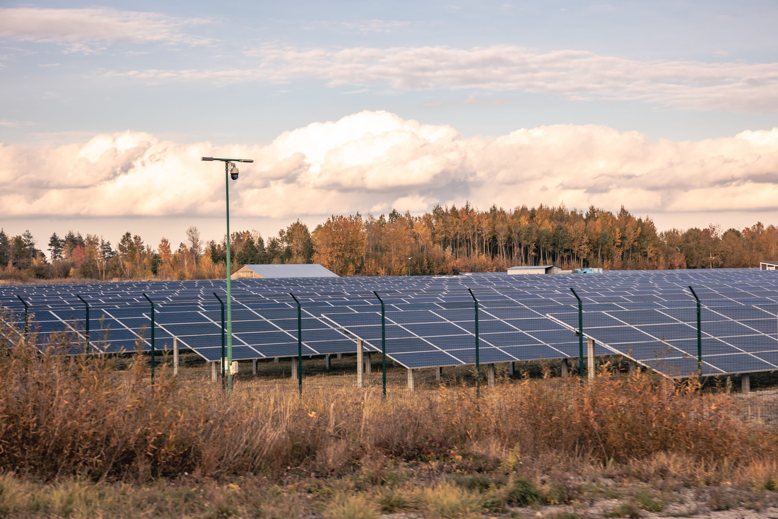 Solar power station in the autumn nature in a rural area.