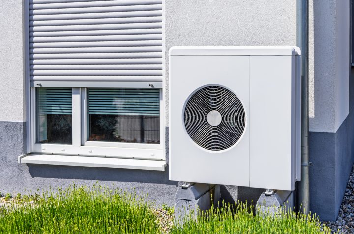 New air source heat pump installed outside of family house