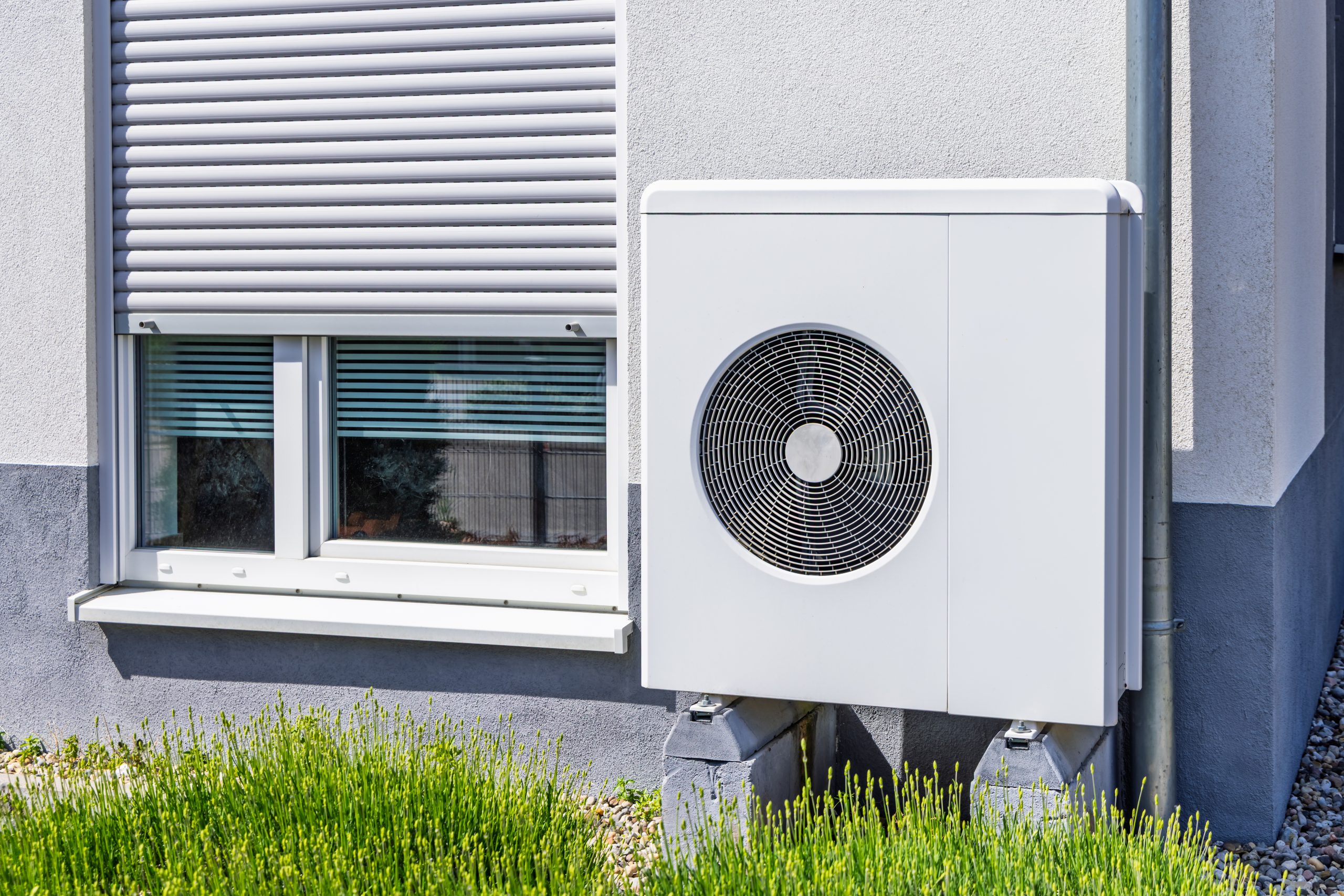 New air source heat pump installed outside of family house