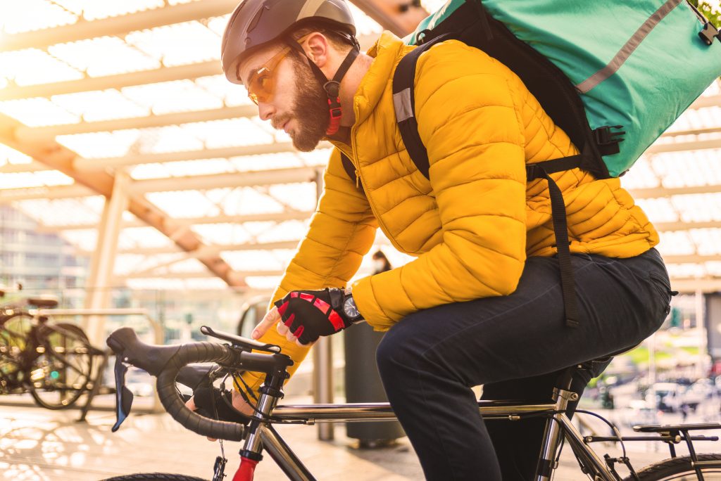 Food delivery service, rider delivering food to clints with bicycle - Concepts about transportation, food delivery and technology