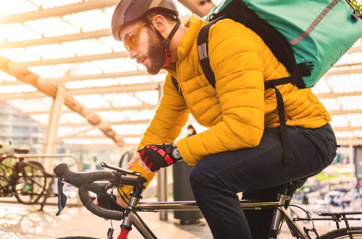 Food delivery service, rider delivering food to clints with bicycle - Concepts about transportation, food delivery and technology