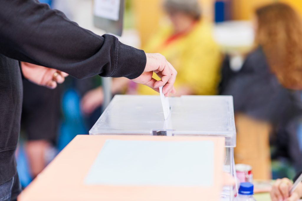 political referendum polling choice voter background with copy space. democratic system. Hispanic voter holding an envelope in an electoral college, Wahlurne, Wahlen