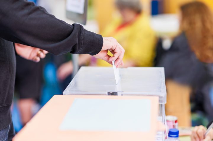 political referendum polling choice voter background with copy space. democratic system. Hispanic voter holding an envelope in an electoral college, Wahlurne, Wahlen